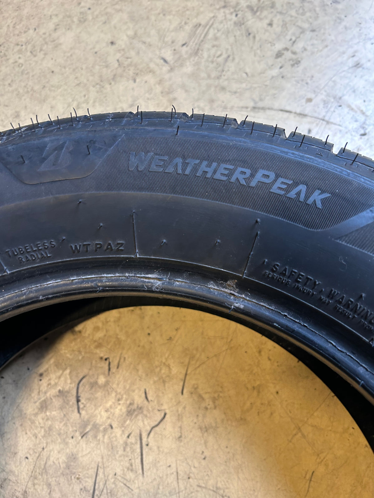 USED 8/32” BRIDGESTONE WEATHERPEAK P 205 60 16 92V ALL WEATHER TIRE 006022